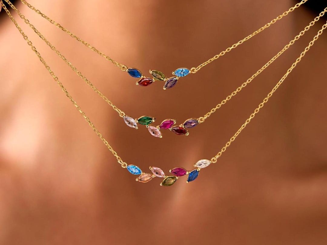 GoldWishJewelery marquise-cut birthstones angled like leaves on a gold chain