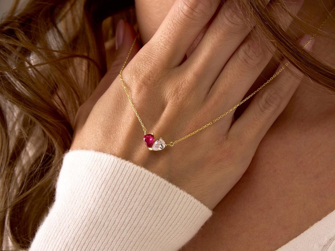 StayChicJewelry hammered gold heart holding two small birthstones on a warm gold chain