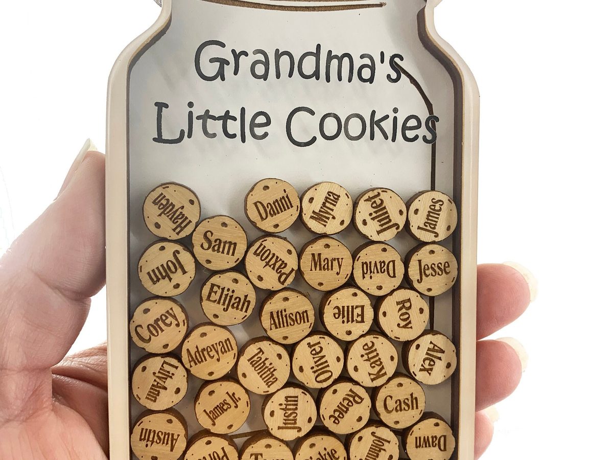 Wooden cookie-jar plaque reading Grandma's Little Cookies, filled with an engraved wooden disc naming each grandchild