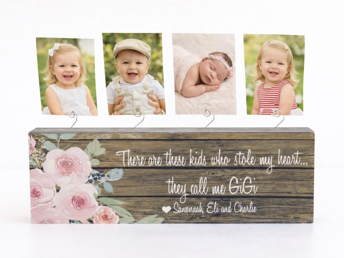 Dark wood photo block with a pink rose design and grandchildren's names, holding four photos on wire clips