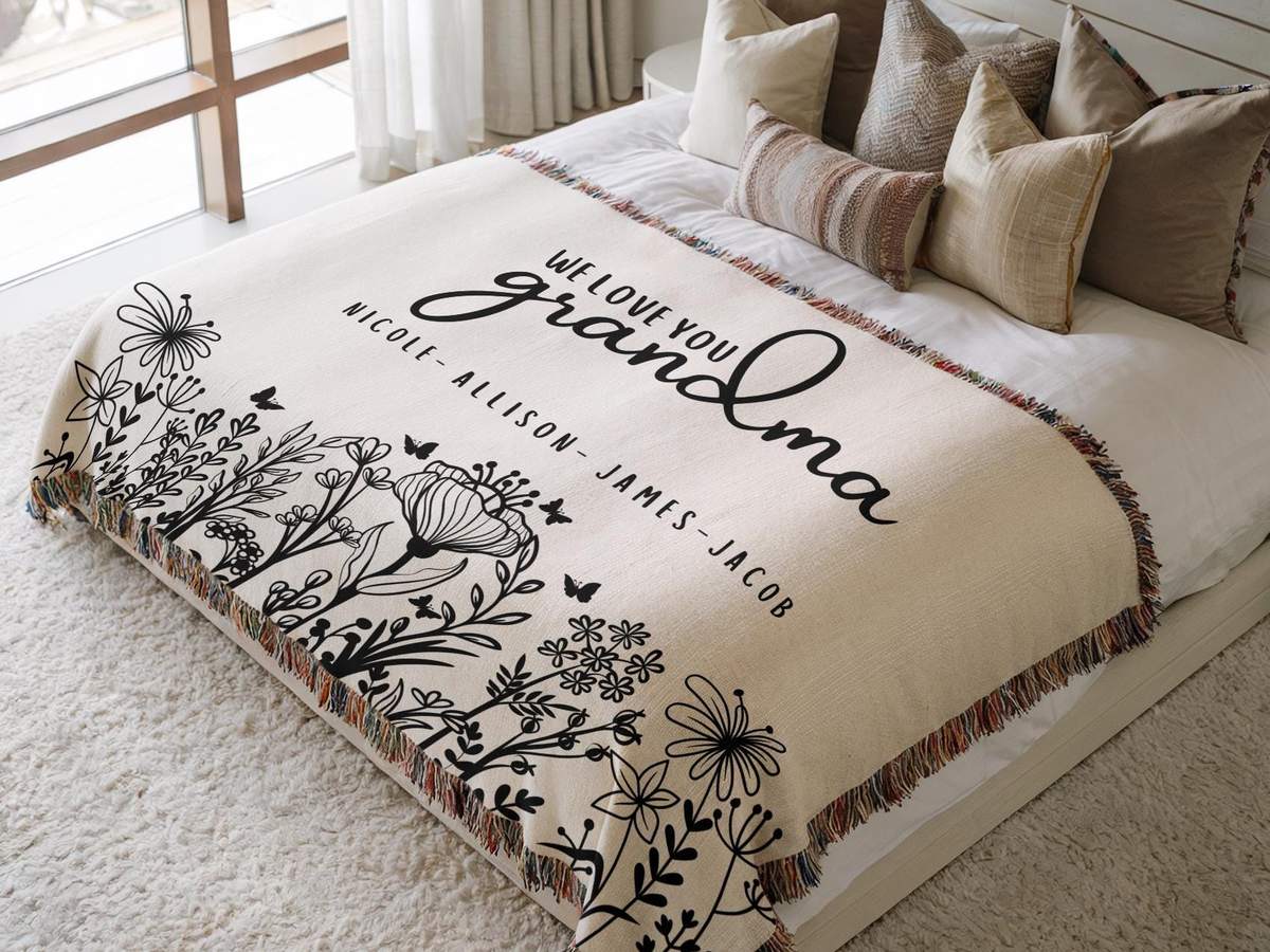 Cream woven cotton throw with a black wildflower design, grandchildren's names and a multicoloured fringe