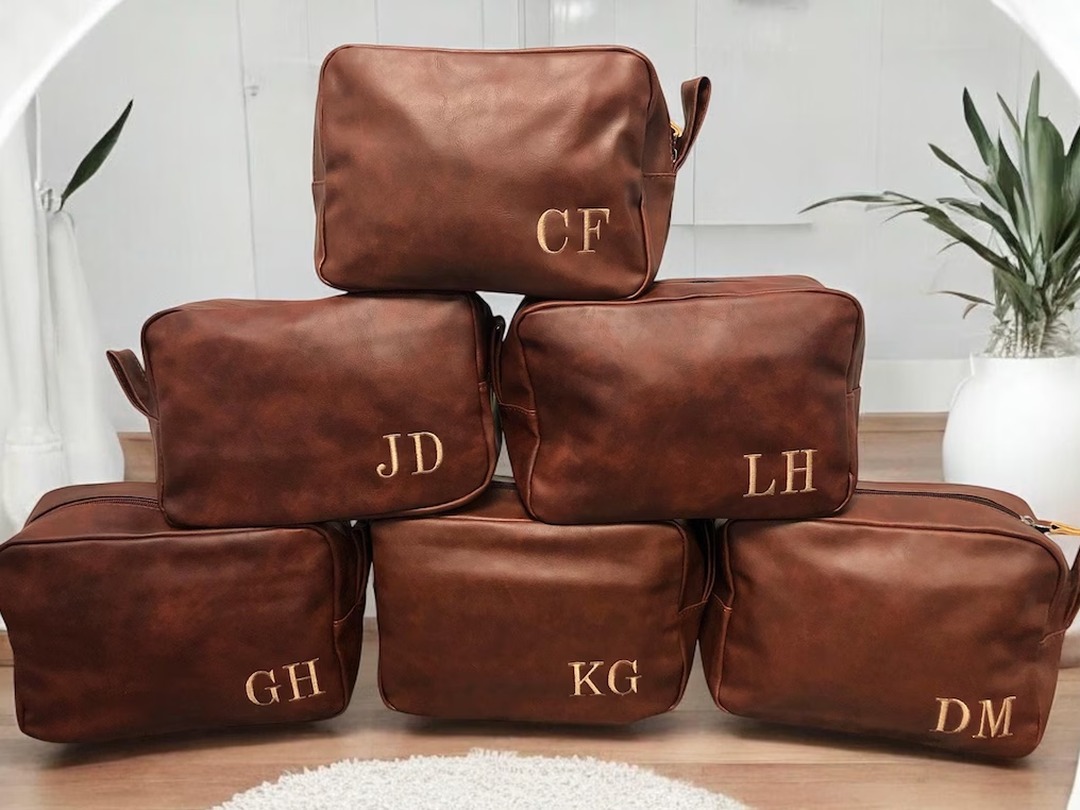 Brown leather shaving kit travel bag with an engraved initial