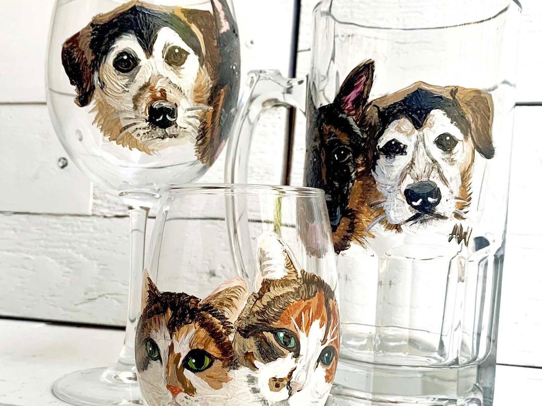 Glass beer stein with a dog's face hand-painted on the side, brushstrokes visible