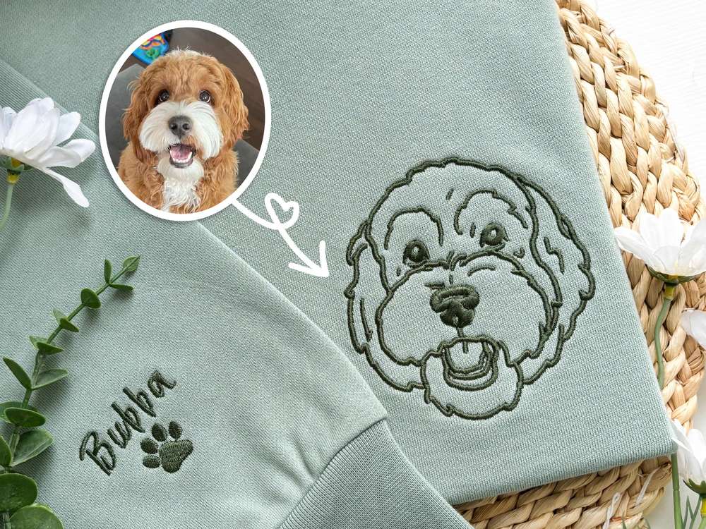 Crewneck sweatshirt with a small embroidered dog face and name stitched on the chest