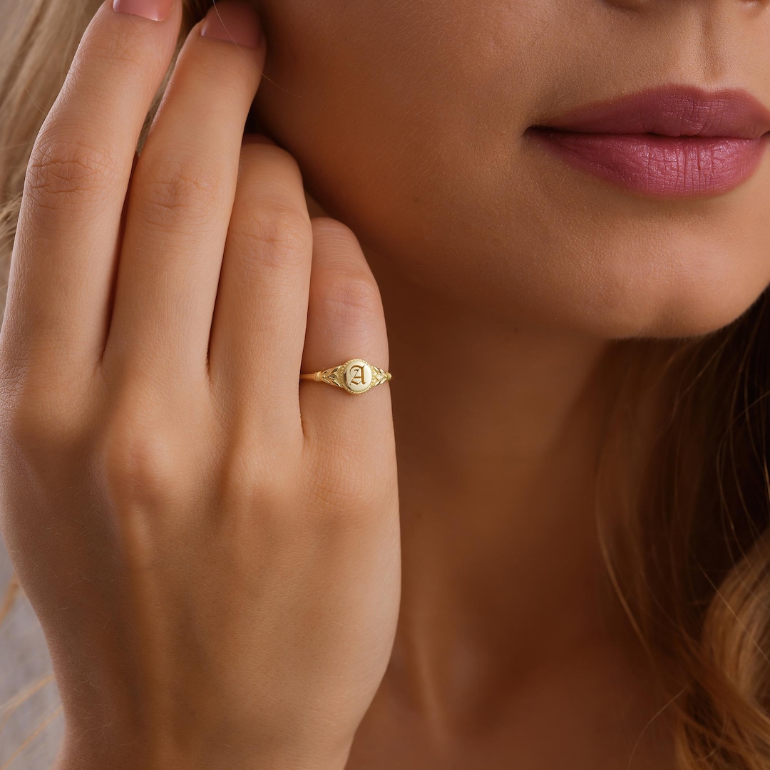 Sterling silver signet pinky ring engraved with a single initial