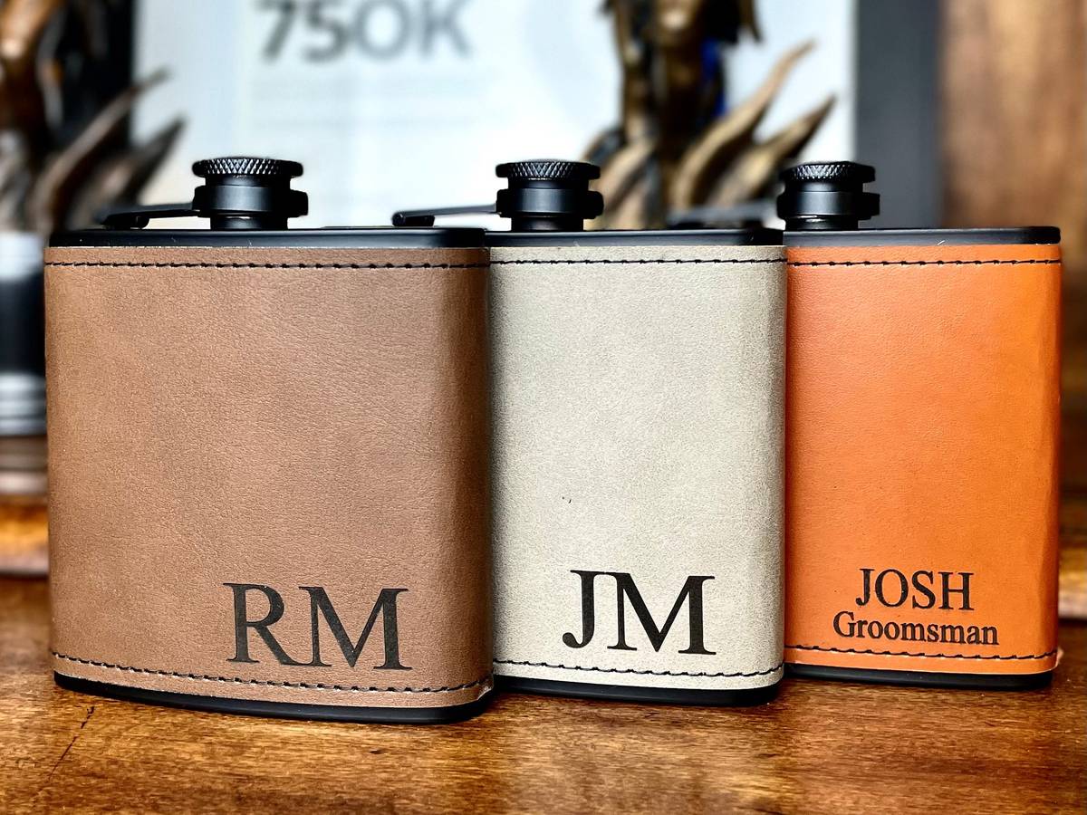 WeddingsDecorandMore leather-wrapped flasks engraved with initials and Groomsman, on Etsy