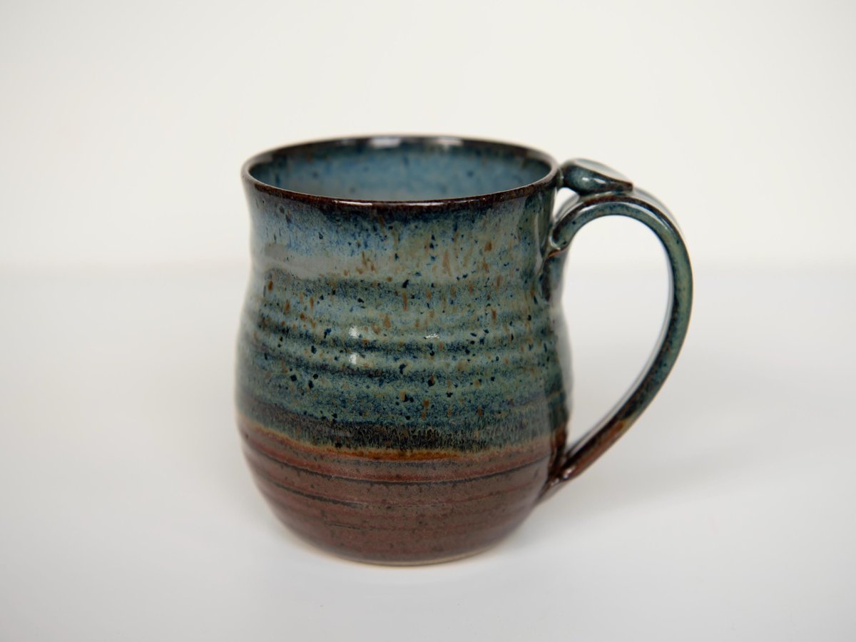 StonehousePotteryOH hand-thrown stoneware mug in blue and rust glaze with a thumb rest, a handmade ceramic mug on Etsy