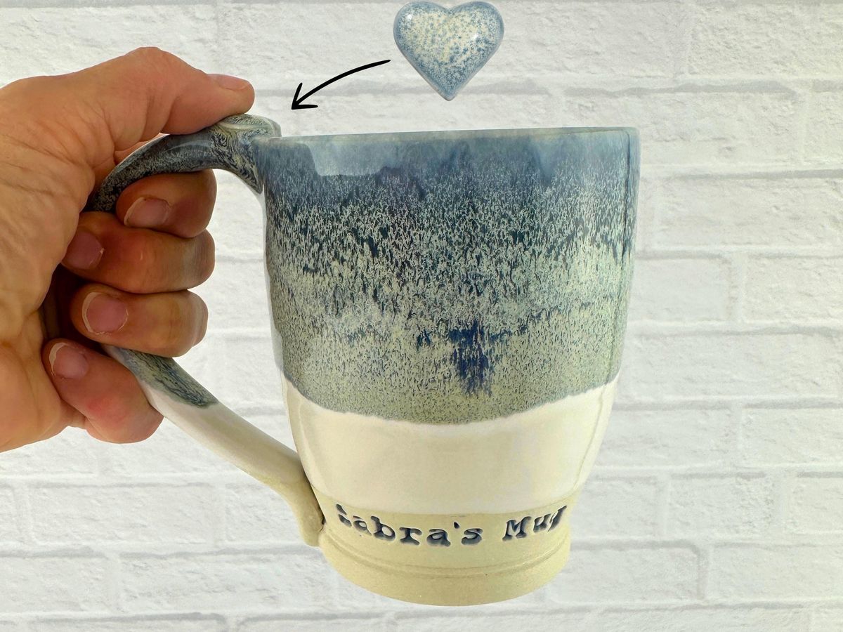 MargieGrodskyPottery personalized blue and cream stoneware mug with a heart thumb rest, a gift on Etsy