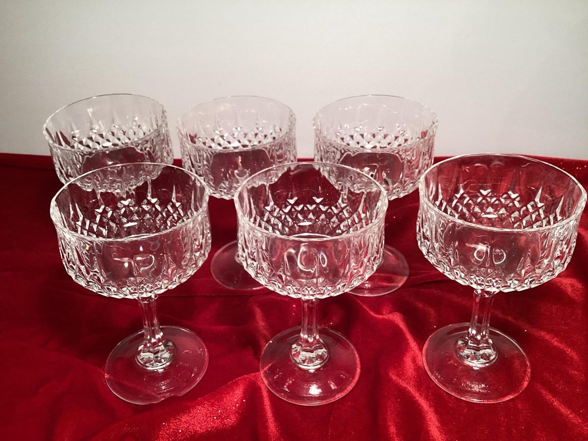 Five clear cut-crystal Cristal d'Arques Longchamp coupe glasses on red velvet, vintage French glass champagne coupes