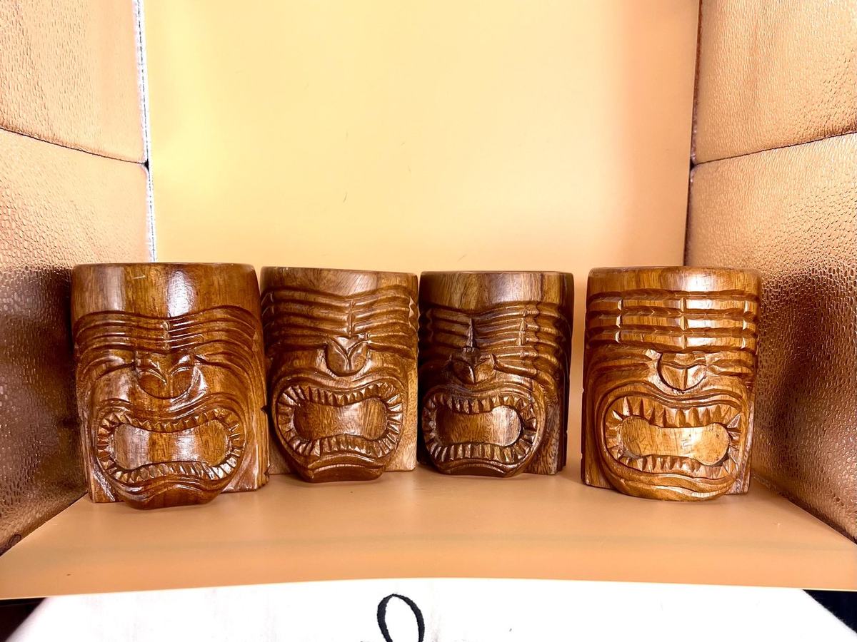 Four brown hand-carved wood Hawaiian tiki mugs from the 1960s, Philippines, vintage tiki bar set